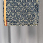 Louis Vuitton monogram denim pants pocket area with orange-trimmed edge