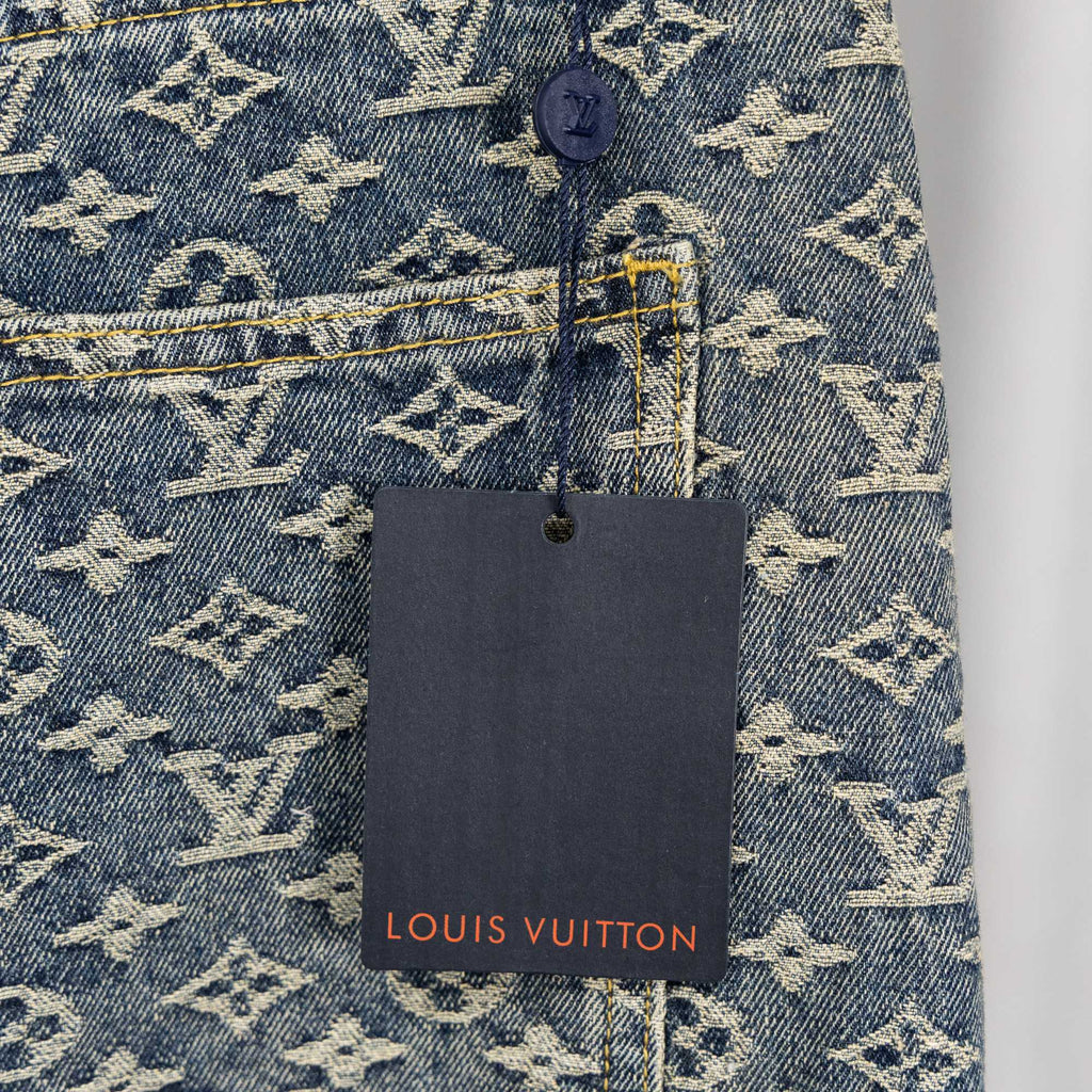 Louis Vuitton monogram denim pants with hanging brand tag near back pocket