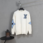 White knit long-sleeve sweater with blue and black logo patch on chest
