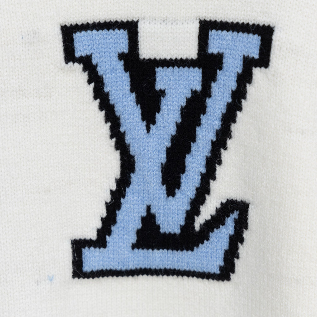 White knit sweater with oversized blue and black LV-style monogram on chest