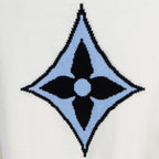 White knit sweater with blue and black diamond monogram logo on front