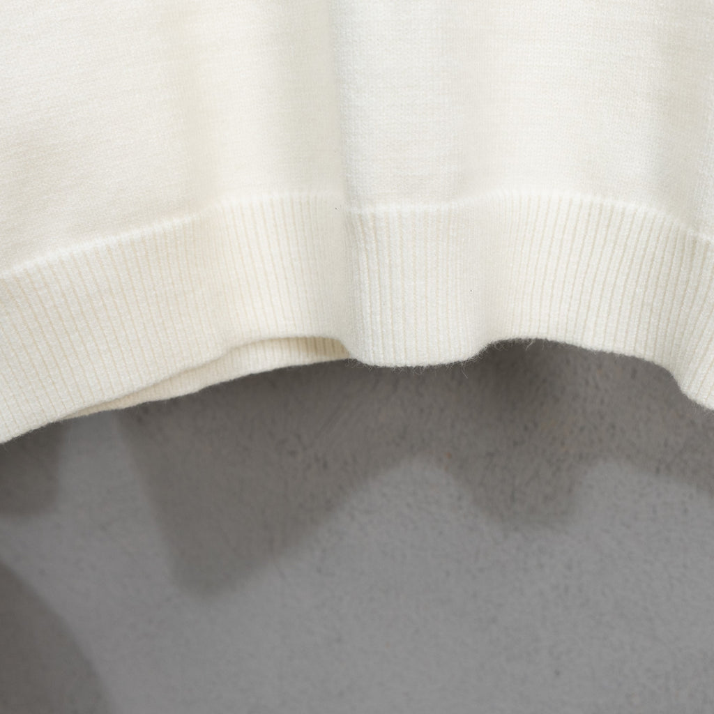 Long-sleeve knit sweater with ribbed hem on off-white fabric