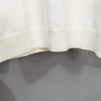 Long-sleeve knit sweater with ribbed hem on off-white fabric