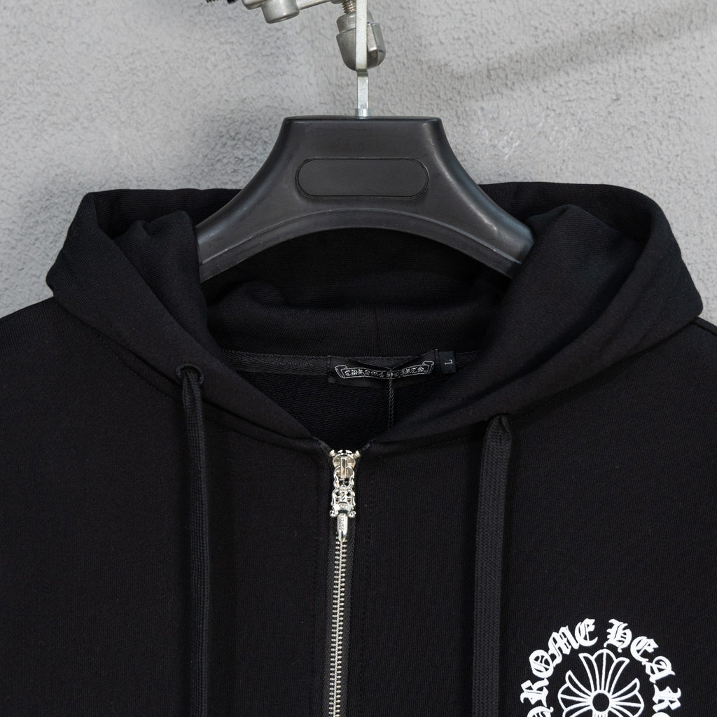 Black zip hoodie close-up with silver zipper and drawstring hood