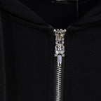 Black hoodie close-up of silver zipper and metal zipper pull