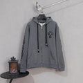 Grey zip-up hoodie with hood and black drawstrings