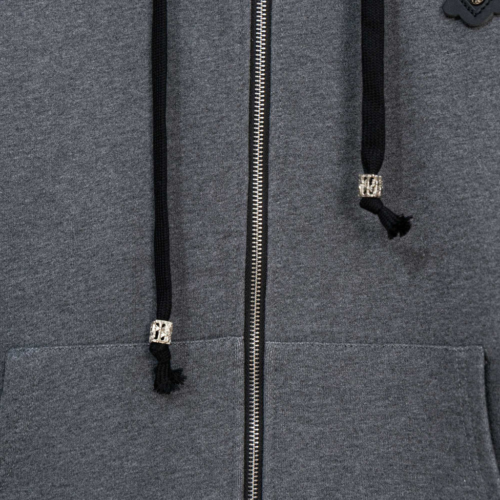 Grey zip-up hoodie close-up of silver zipper and front pockets