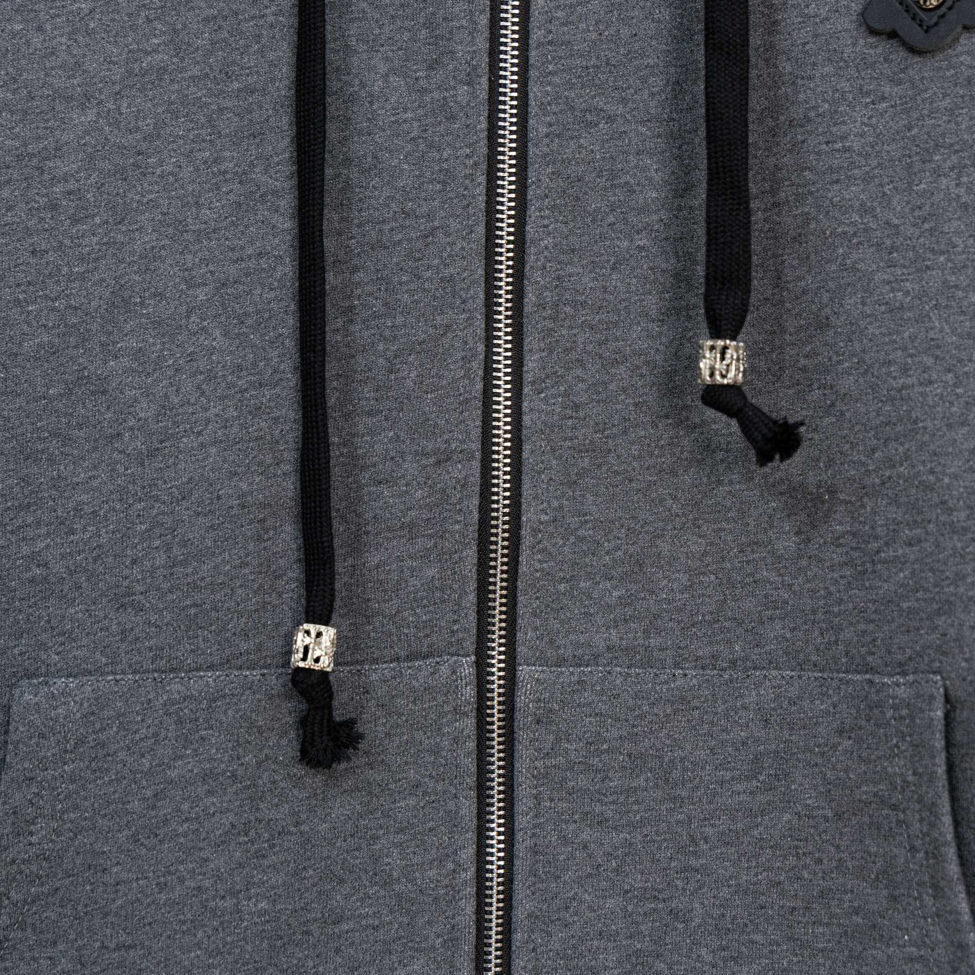 Grey zip-up hoodie close-up of silver zipper and front pockets
