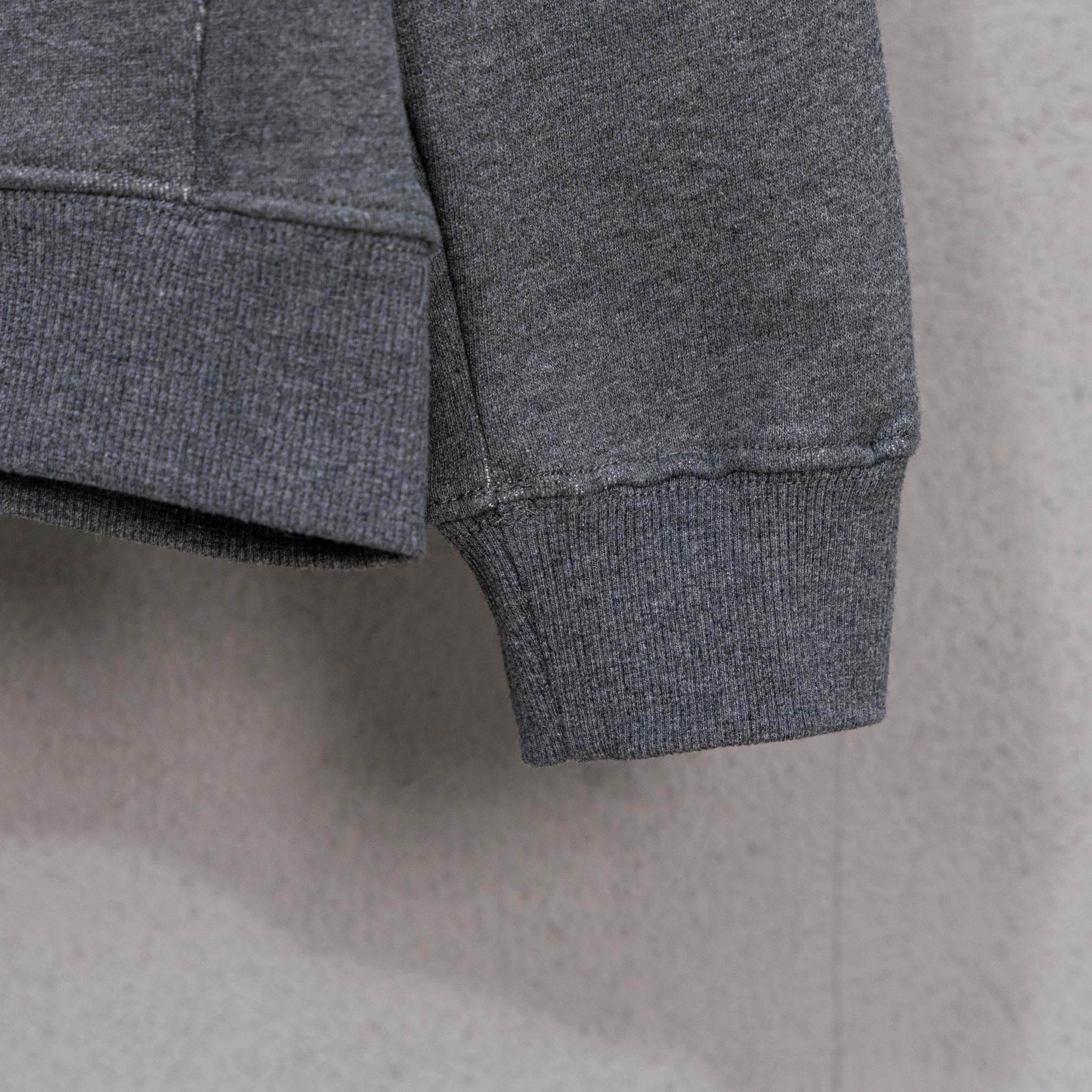 Grey zip-up hoodie hem and cuffs with ribbed knit trim