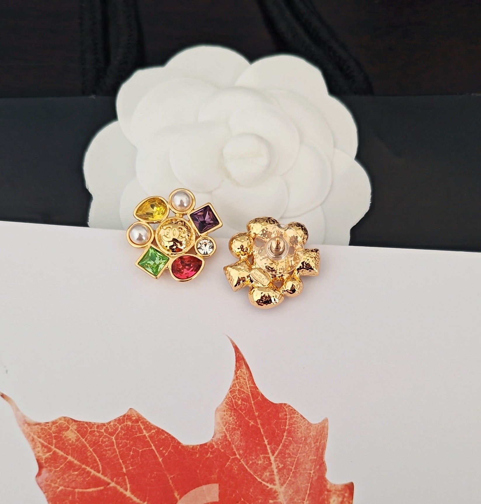 Gold-tone Chanel stud earrings with floral crystal clusters and pearl accents