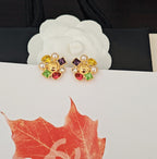 Gold-tone Chanel stud earrings with colorful crystal clusters and pearl accents