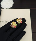 Gold-tone jeweled Chanel stud earrings with pearl accents and colorful crystals