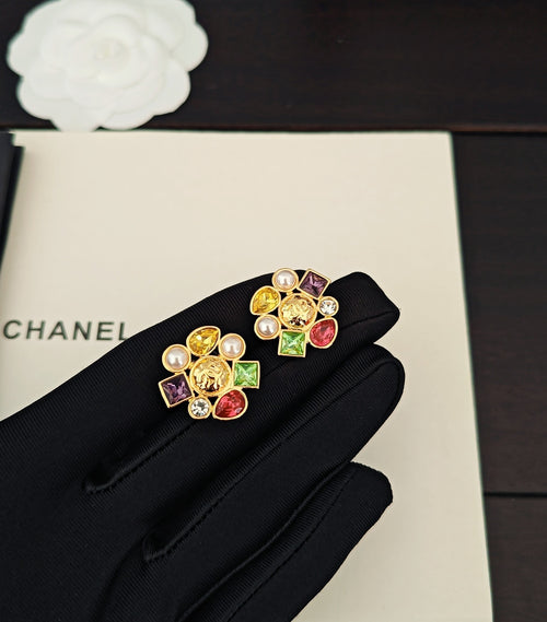 Gold-tone jeweled Chanel stud earrings with pearl accents and colorful crystals