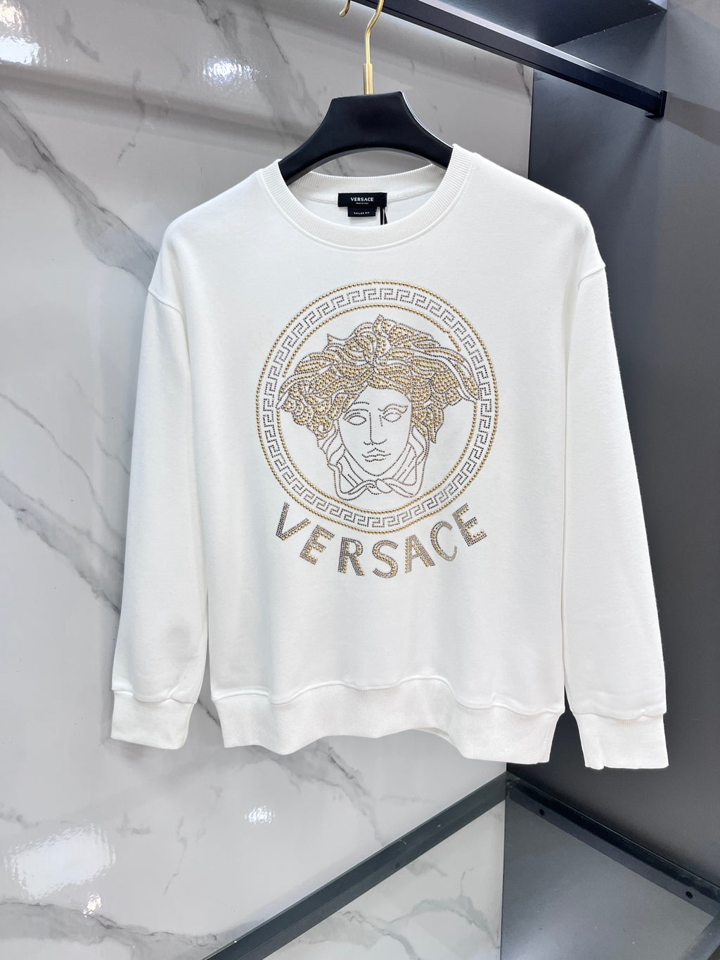 White crewneck sweatshirt with gold Versace rhinestone medallion logo