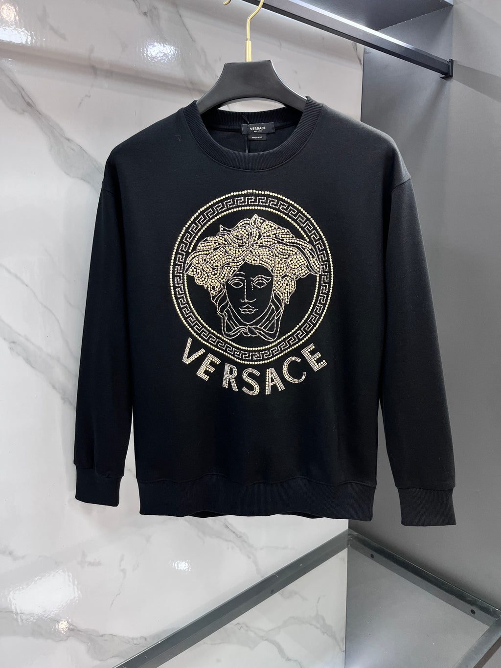 Black crewneck sweatshirt with gold Versace rhinestone medallion logo