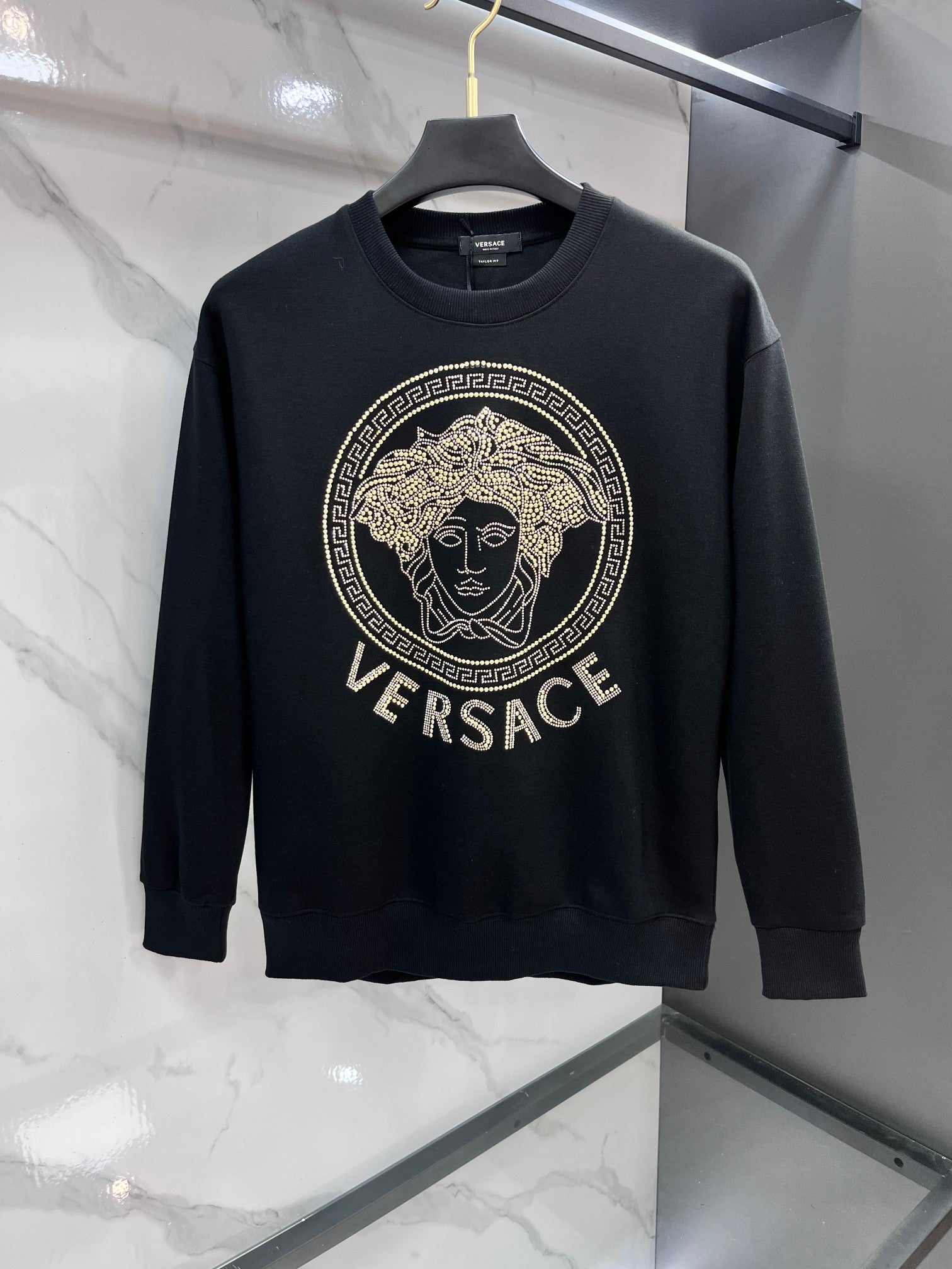 Black crewneck sweatshirt with gold Versace rhinestone medallion logo