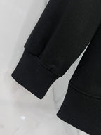 Black crewneck sweatshirt sleeve and ribbed cuff detail