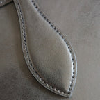 CELINE tote bag close-up of curved leather panel with stitched edge.