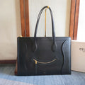 CELINE tote bag in dark leather with top handles and front zip pocket.