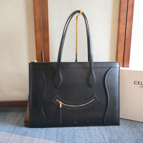 CELINE tote bag in dark leather with top handles and front zip pocket.