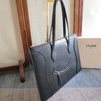 CELINE tote bag, dark leather, side view with top handles and front zip detail.