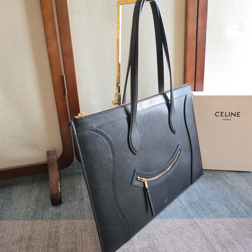 CELINE tote bag, dark leather, side view with top handles and front zip detail.