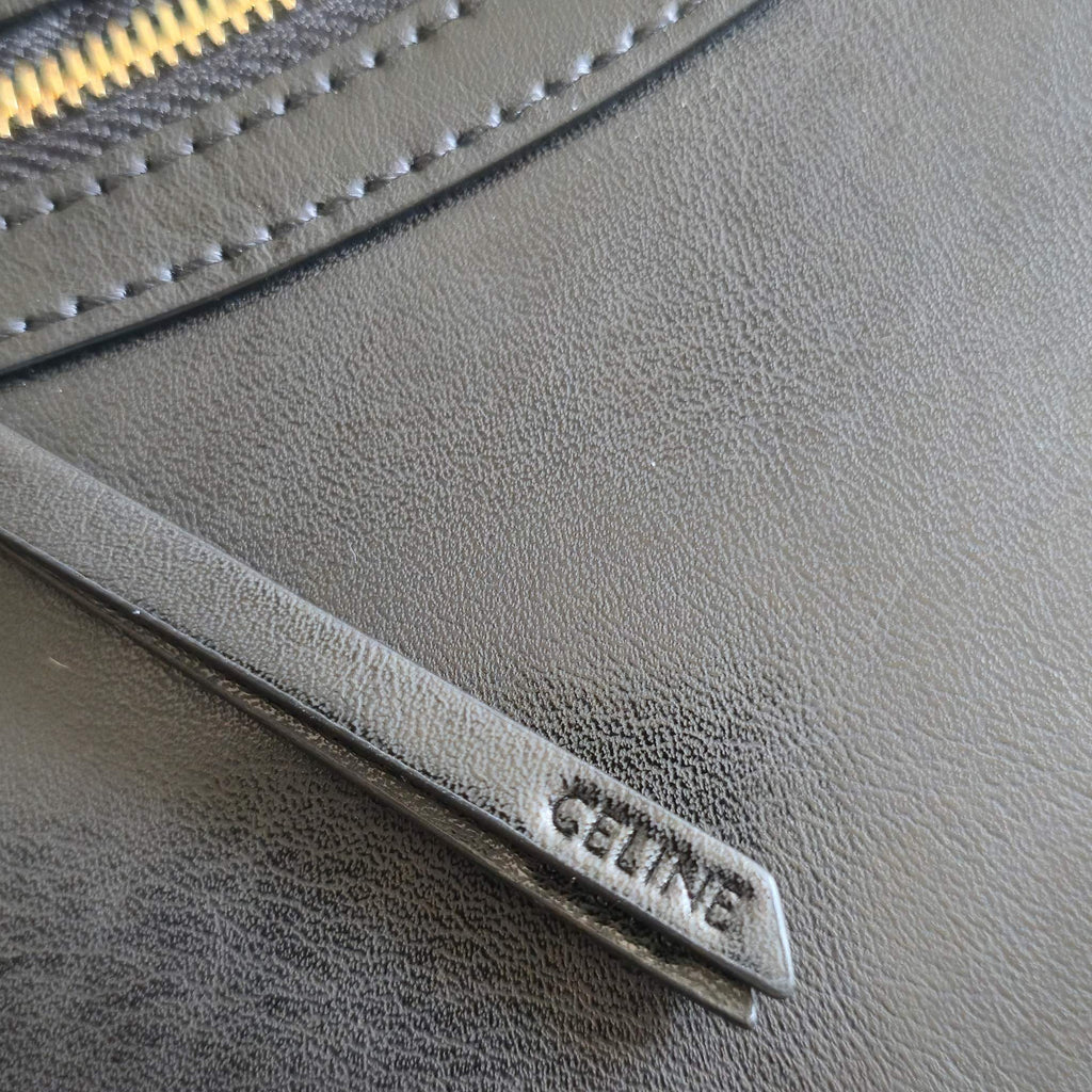 CELINE tote bag close-up of leather zipper trim with CELINE label plaque.
