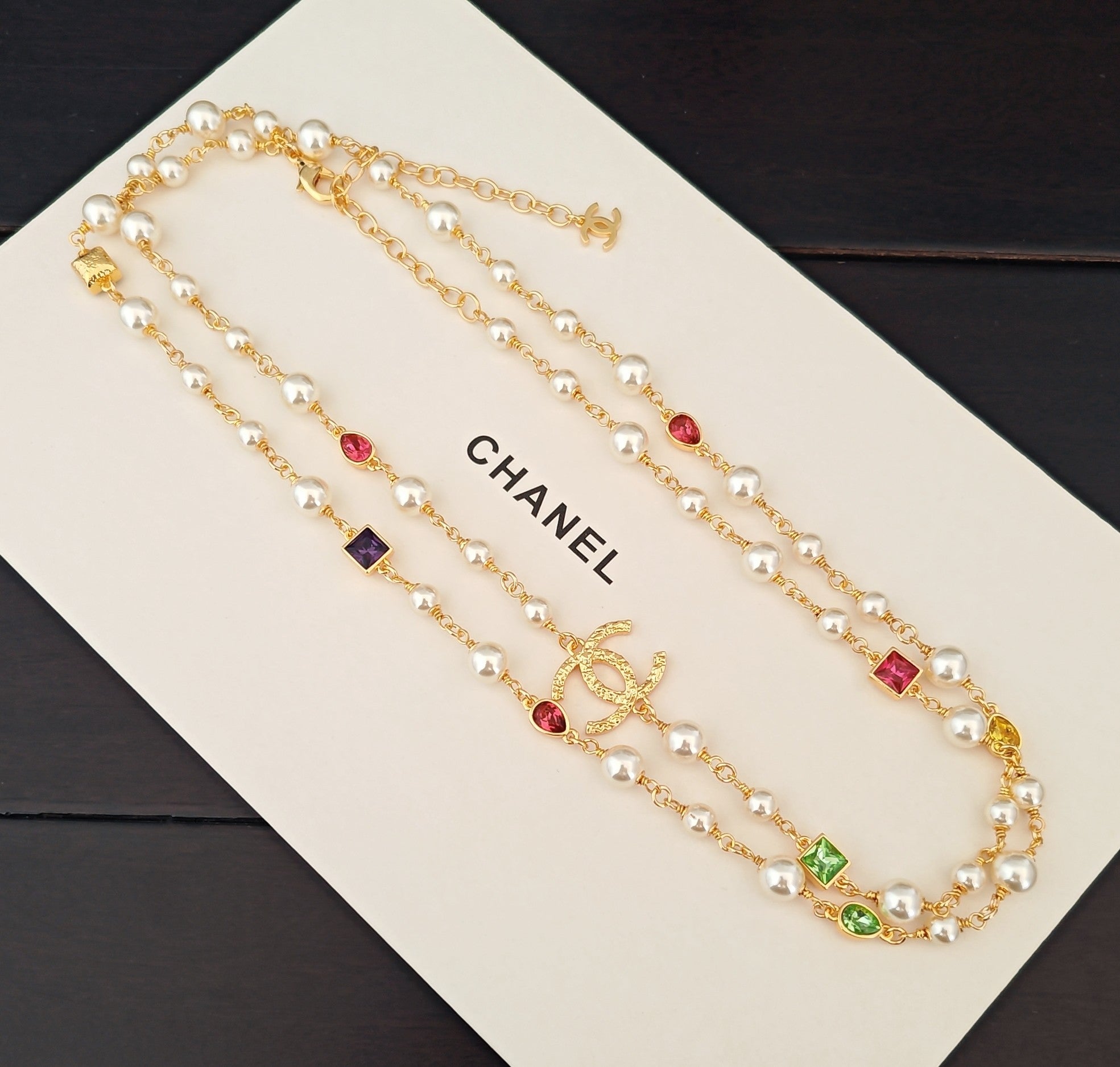 Gold-tone layered necklace set with pearl-like beads, red and blue crystals, CHANEL charm