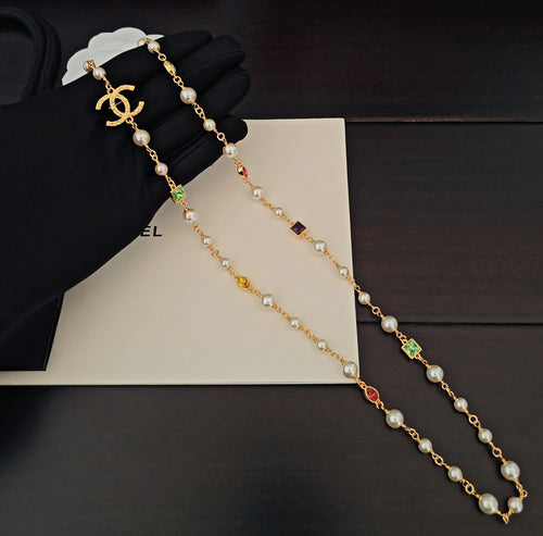 Gold-tone beaded necklace with pearl-like beads and multicolor crystal charms