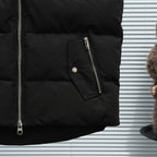 Black sleeveless puffer vest with side zip pocket and metal zipper pull