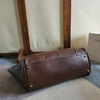 Brown leather tote bag with rolled handles and structured base