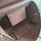 Brown leather tote bag interior with main compartment and side zip pocket