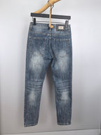 Blue denim pants on hanger with back pockets and waistband belt loops