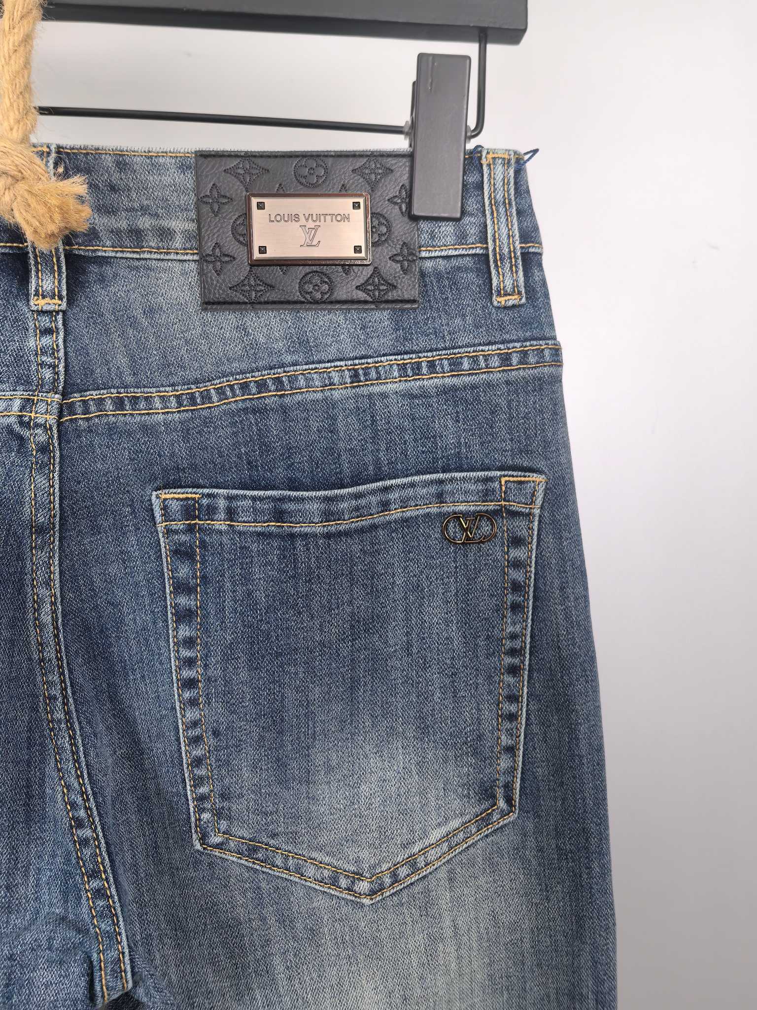 Blue denim pants back view with rectangular patch label and stitched back pocket
