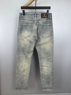 Washed light-blue denim jeans with back pockets and button closure