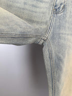 Light-blue denim jeans hem with contrast topstitching