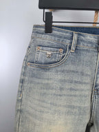 Light-blue denim jeans back yoke with embellished button pocket