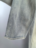 Light-blue denim jeans leg with straight seam and cuff detail