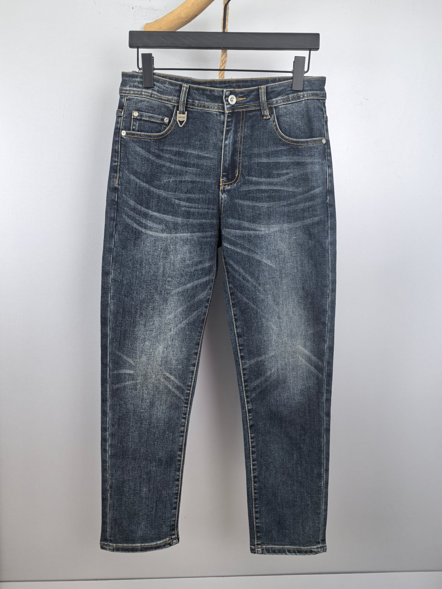 Dark blue denim pants with button fly, belt loops, and front pockets.