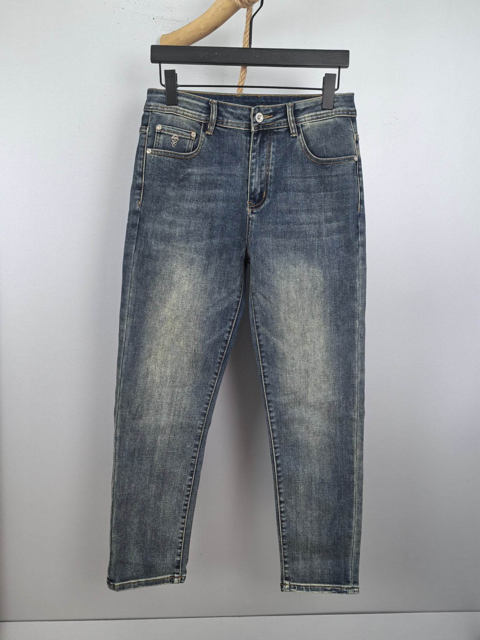 Men's blue denim pants with belt loops and button fly