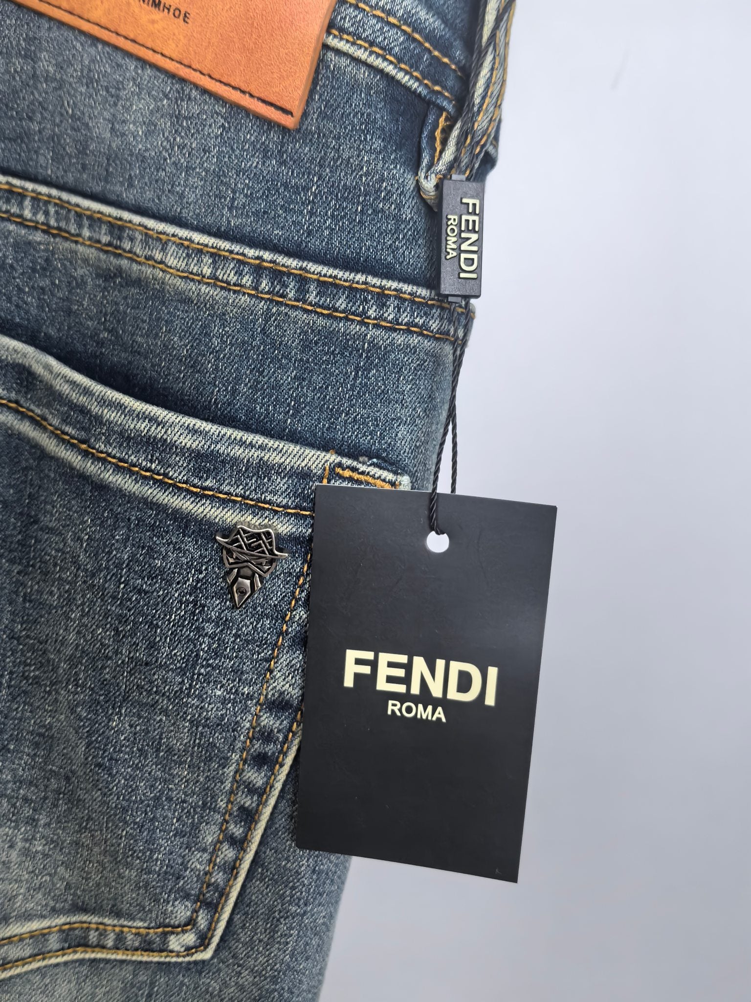 Fendi-tagged blue denim pants with embroidered logo on front pocket