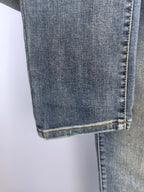 Blue denim pants hem with double stitching and vertical seam detail