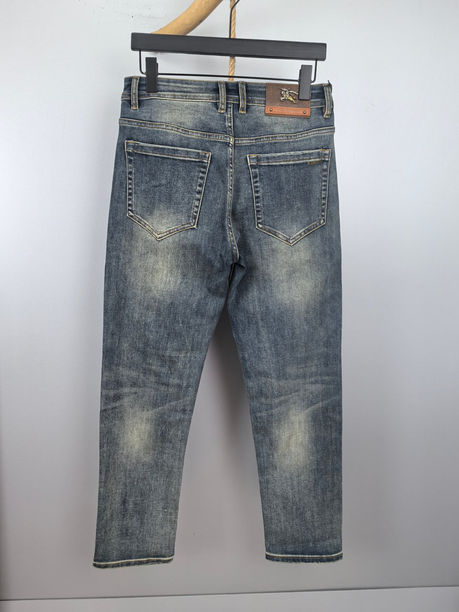 Burberry denim jeans with stitched back yoke, belt loops and dark blue wash