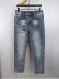 Blue denim pants with belt loops, button fly, and classic front pockets
