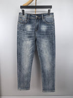 Blue denim pants with belt loops, button fly, and classic front pockets
