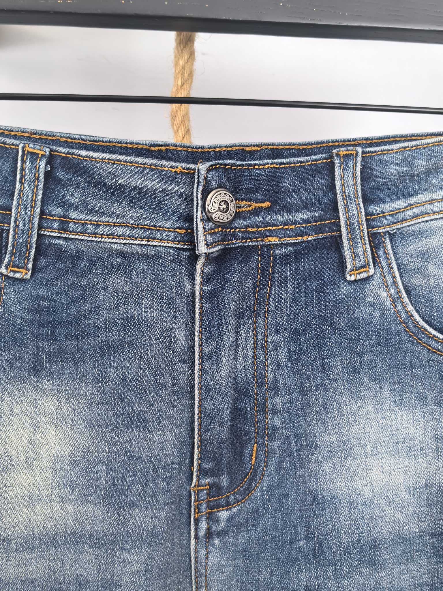 Dark blue denim waistband with button closure and belt loops