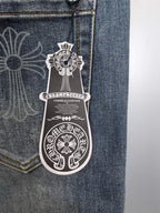 Blue denim pants pocket close-up with logo patch artwork