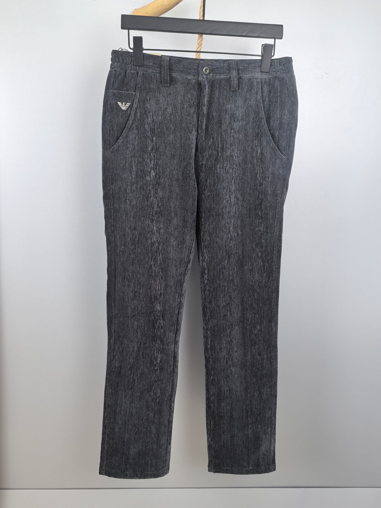 Charcoal textured trousers with belt loops, zip fly, button closure, and straight legs.