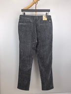 Dark charcoal trousers with belt loops and zip fly, shown from the front on a hanger.