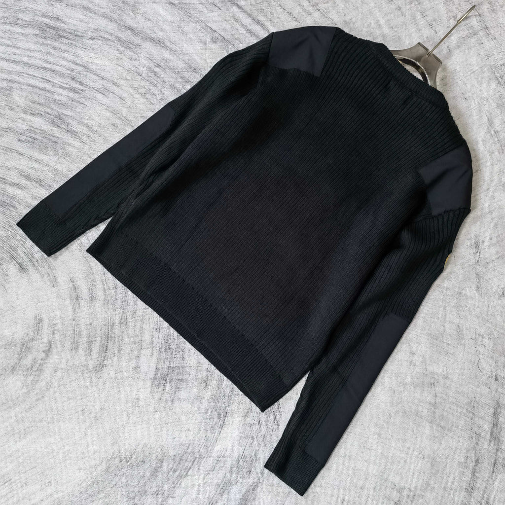 Balenciaga long-sleeve knit sweater laid flat, ribbed knit texture and crew neck
